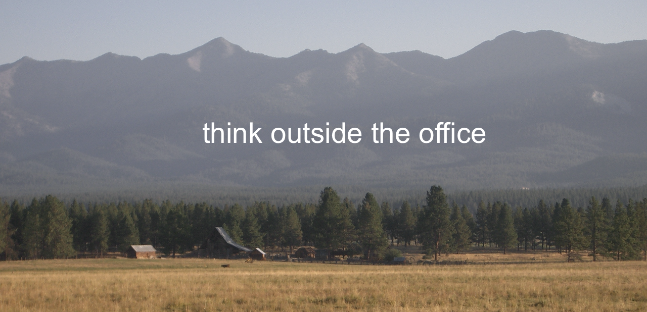 A photograph of the Elkhorn Mountains in northeastern Oregon, with the motto "think outside the office."